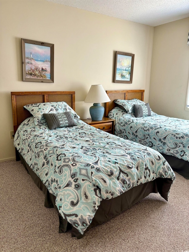 carpeted bedroom with a textured ceiling