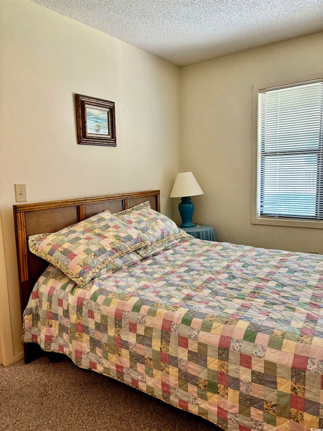 carpeted bedroom featuring a textured ceiling