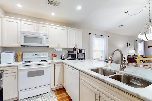 kitchen with light hardwood / wood-style floors, sink, white appliances, and white cabinetry