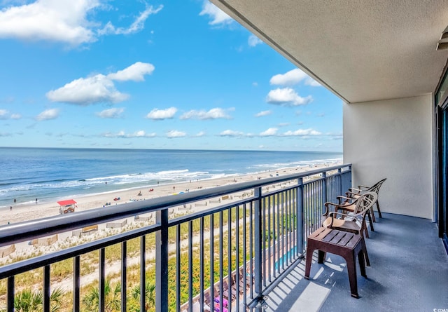 balcony with a view of the beach and a water view