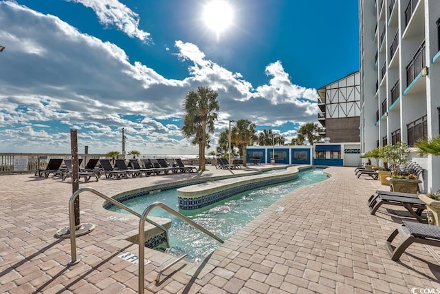 view of swimming pool featuring a patio area