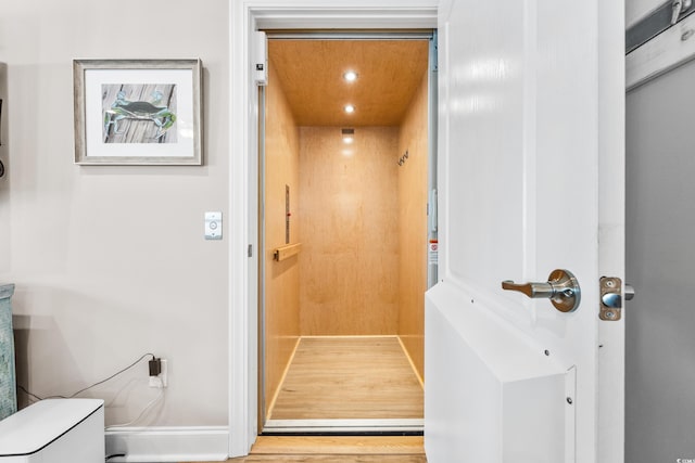 bathroom with hardwood / wood-style floors