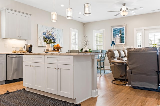 kitchen featuring stainless steel dishwasher, wood-type flooring, ceiling fan, and white cabinets