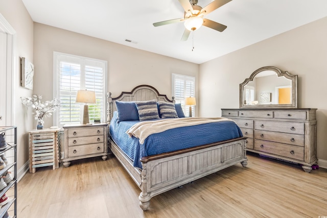 bedroom with light hardwood / wood-style floors and ceiling fan