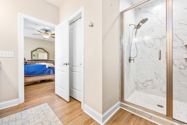 bathroom featuring walk in shower, ceiling fan, and hardwood / wood-style flooring