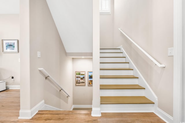 stairs featuring light hardwood / wood-style floors