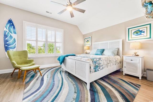 bedroom featuring hardwood / wood-style flooring, ceiling fan, and lofted ceiling