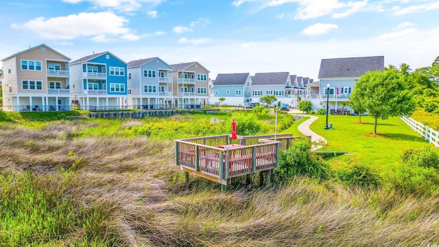 view of home's community featuring a deck and a yard