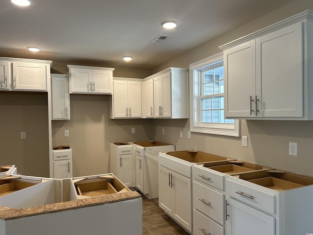 kitchen featuring dark hardwood / wood-style flooring, white cabinetry, and a center island