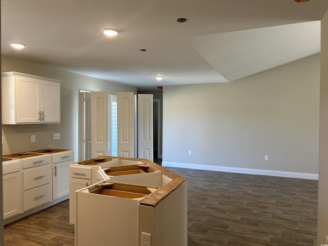 kitchen with dark hardwood / wood-style flooring, white cabinets, and sink