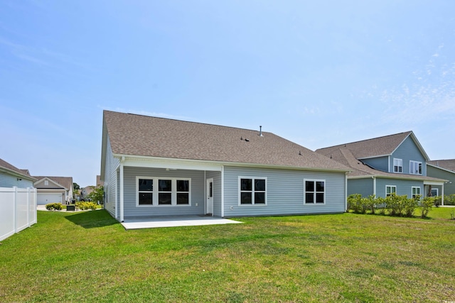 rear view of house featuring a lawn and a patio area