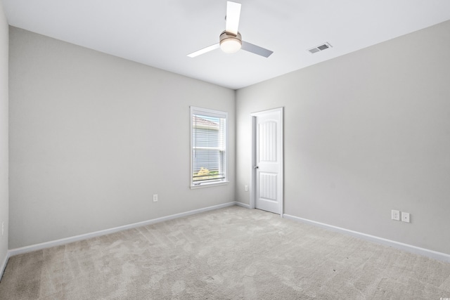 spare room with light carpet and ceiling fan