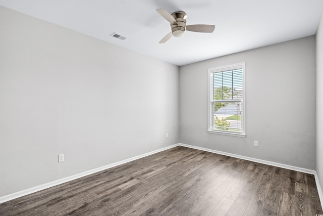 spare room featuring dark hardwood / wood-style flooring and ceiling fan