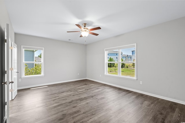 spare room featuring dark hardwood / wood-style flooring and ceiling fan