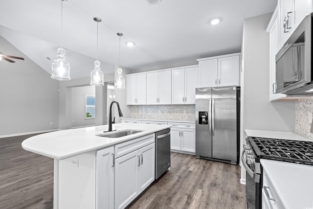 kitchen with white cabinets, a center island with sink, appliances with stainless steel finishes, and sink