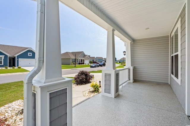 view of patio / terrace featuring a garage and covered porch