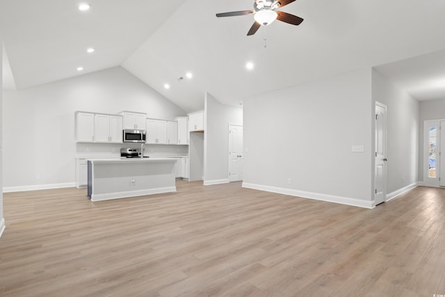 unfurnished living room featuring high vaulted ceiling, ceiling fan, and light hardwood / wood-style flooring