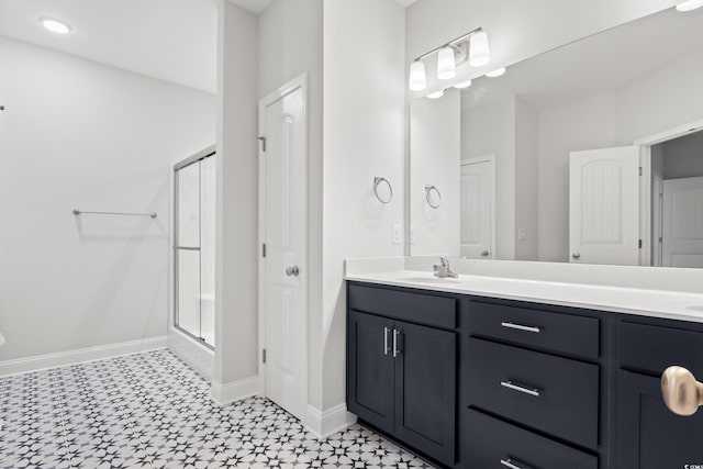 bathroom featuring vanity and a shower with door