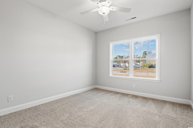 carpeted spare room with ceiling fan