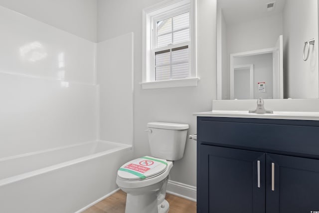 bathroom with vanity, hardwood / wood-style flooring, and toilet