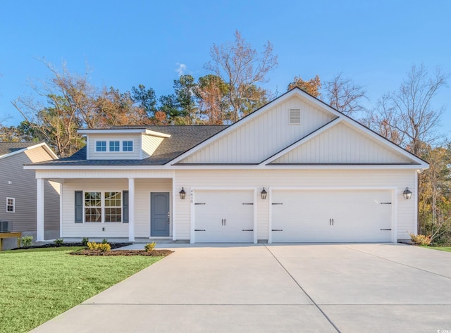 view of front of property with a garage, a front yard, and central air condition unit