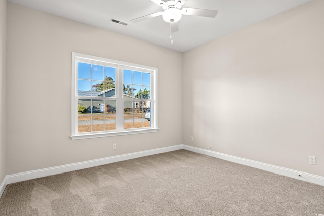 carpeted empty room featuring ceiling fan