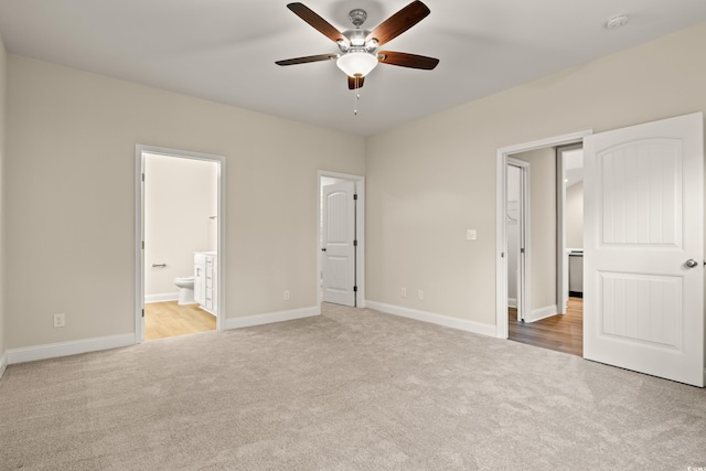 unfurnished bedroom featuring connected bathroom and light colored carpet