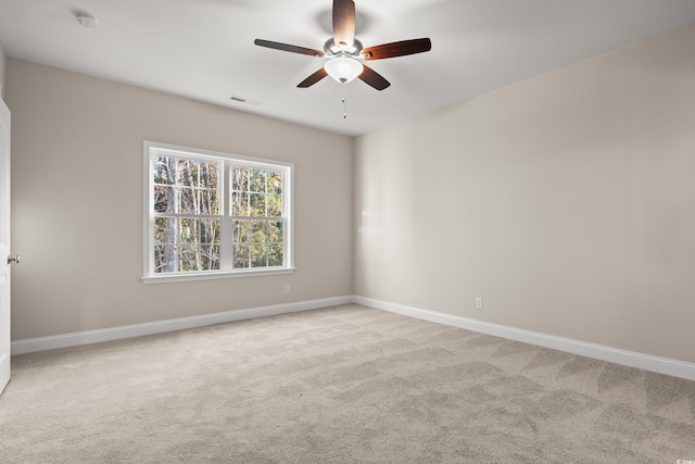 carpeted spare room featuring ceiling fan