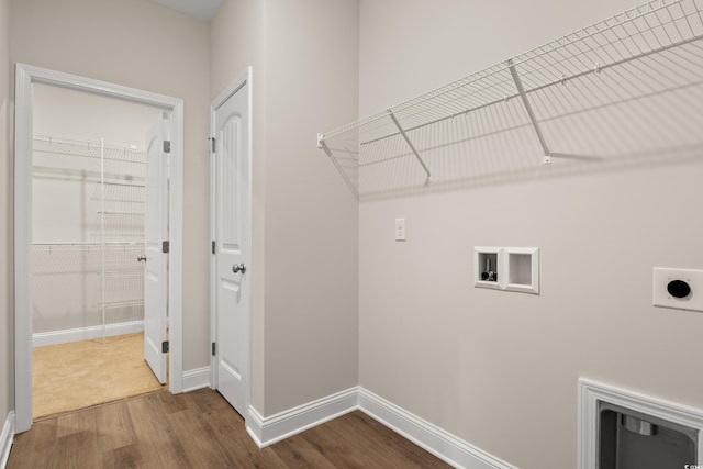 clothes washing area with electric dryer hookup, hookup for a washing machine, and wood-type flooring