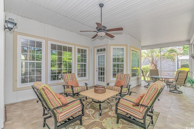 sunroom / solarium featuring ceiling fan