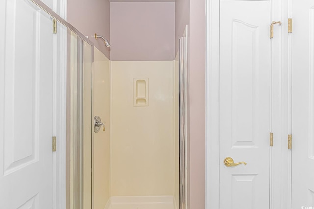 bathroom with a shower with door