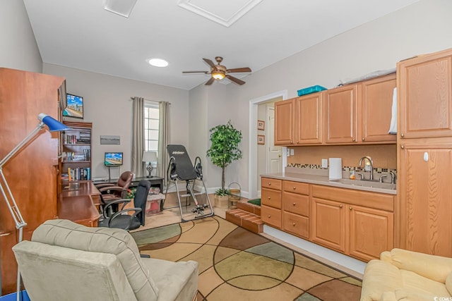 home office featuring ceiling fan and sink