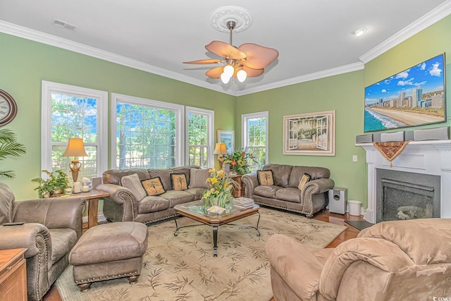 living room featuring ceiling fan and ornamental molding