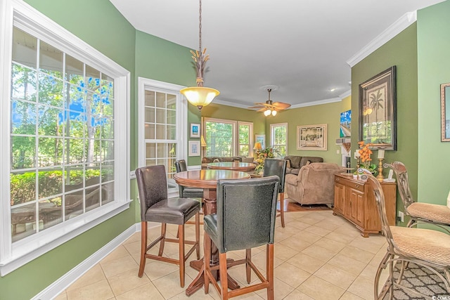 dining room featuring ceiling fan, light tile patterned floors, and ornamental molding