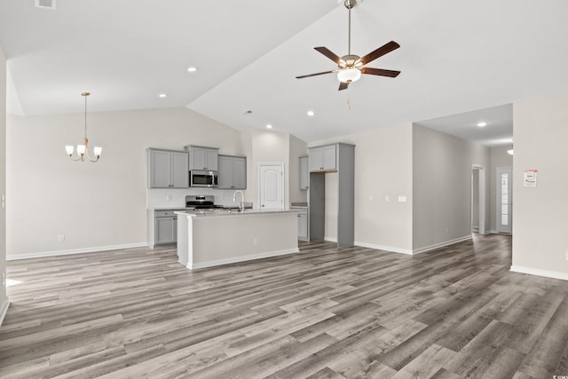 kitchen featuring light wood-type flooring, ceiling fan with notable chandelier, stainless steel appliances, and gray cabinets