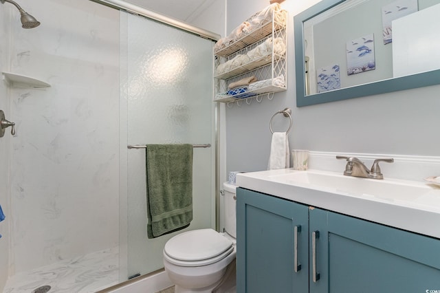 bathroom featuring walk in shower, toilet, and vanity with extensive cabinet space