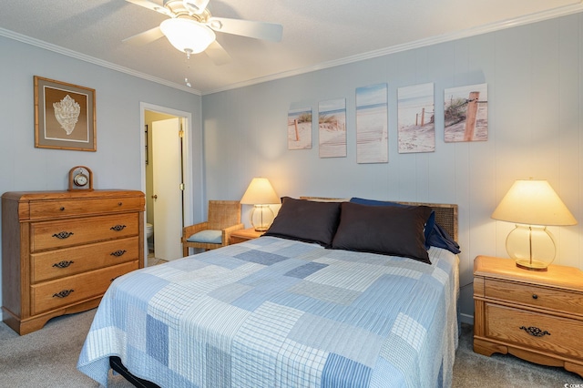 carpeted bedroom featuring ceiling fan and crown molding