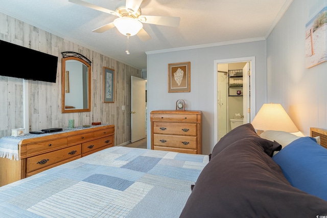 bedroom featuring ceiling fan, a closet, crown molding, and ensuite bath