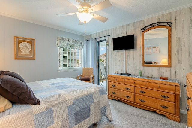 carpeted bedroom featuring a textured ceiling, ornamental molding, ceiling fan, and access to exterior