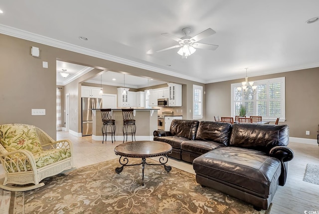 living room with ceiling fan with notable chandelier and crown molding