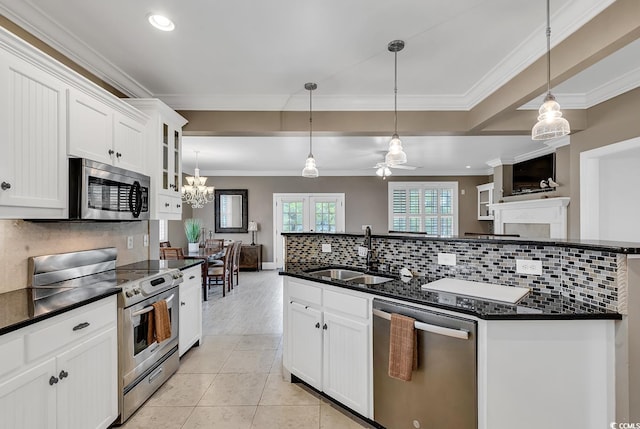 kitchen with hanging light fixtures, white cabinetry, sink, and appliances with stainless steel finishes