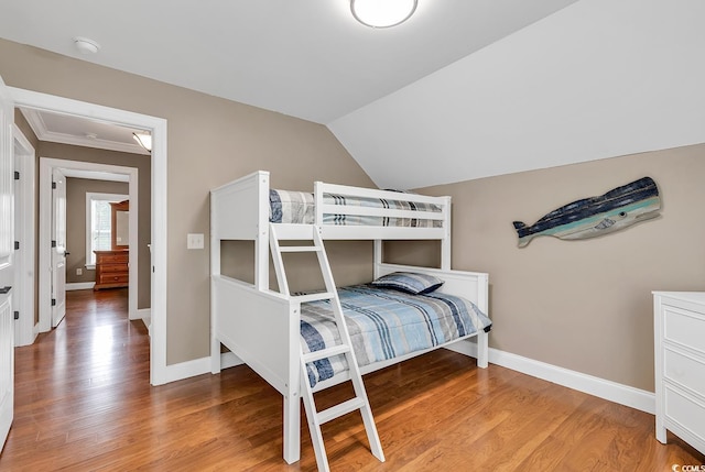 bedroom with wood-type flooring and lofted ceiling