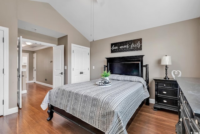 bedroom with dark wood-type flooring and lofted ceiling