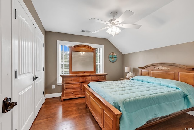 bedroom featuring ceiling fan, vaulted ceiling, dark hardwood / wood-style flooring, and a closet