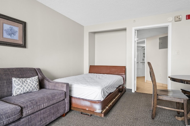 carpeted bedroom featuring a textured ceiling