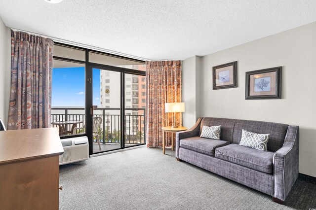 living room with carpet flooring, expansive windows, and a textured ceiling