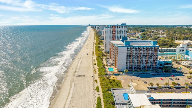 drone / aerial view featuring a water view and a beach view