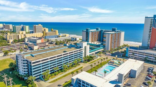 birds eye view of property with a beach view and a water view