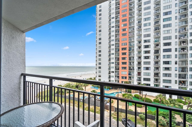 balcony with a view of the beach and a water view