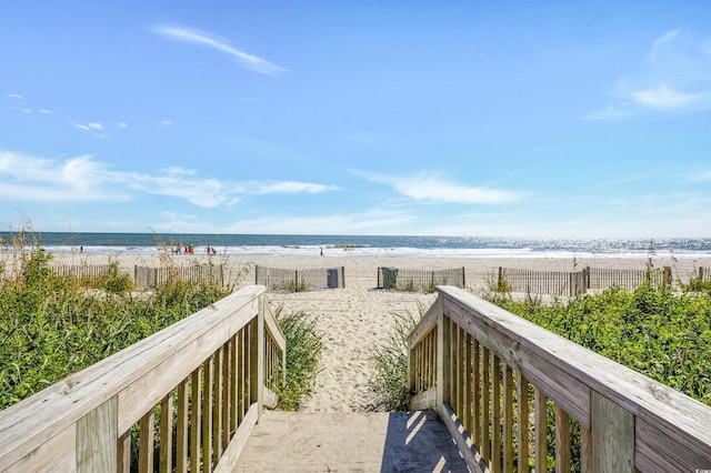 exterior space featuring a water view and a view of the beach